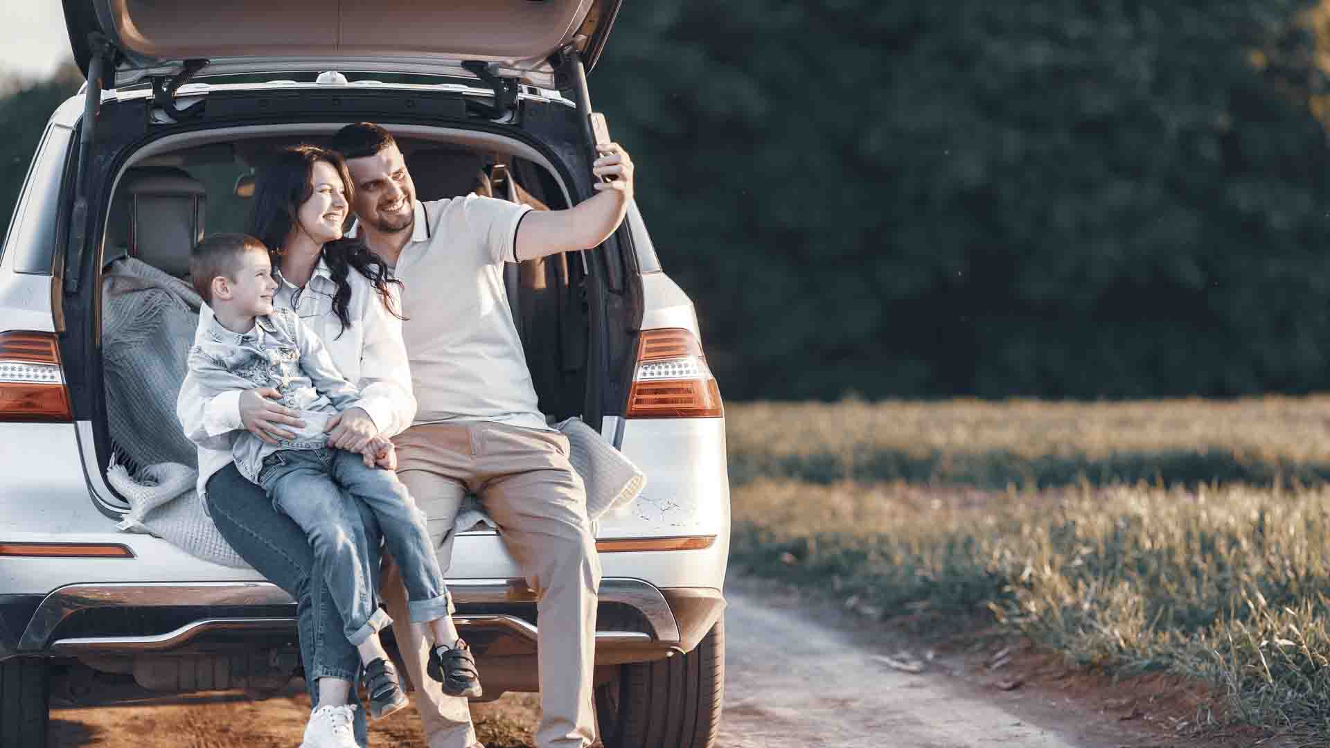 Family in a forest. People by the car. Sunset background.