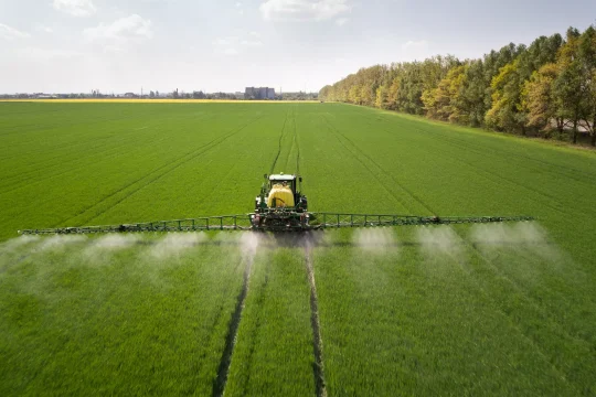 tractor-spraying-pesticides-with-sprayer-large-green-agricultural-field
